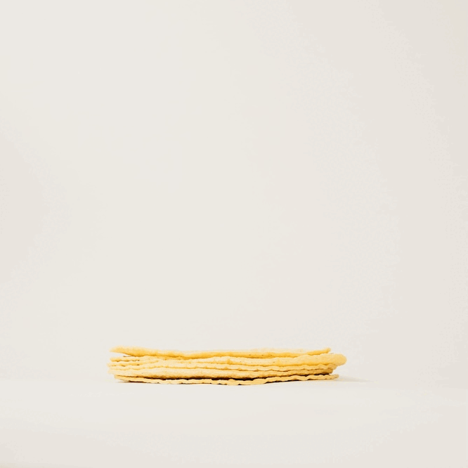 Fun gif of a person touching a stack of soft tortilla chips and turning into fried beef tallow tortilla chips